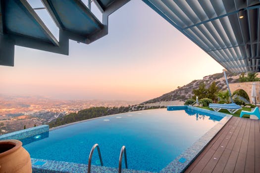 Infinity pool with breathtaking mountain and city views, perfect for a luxury tropical getaway.